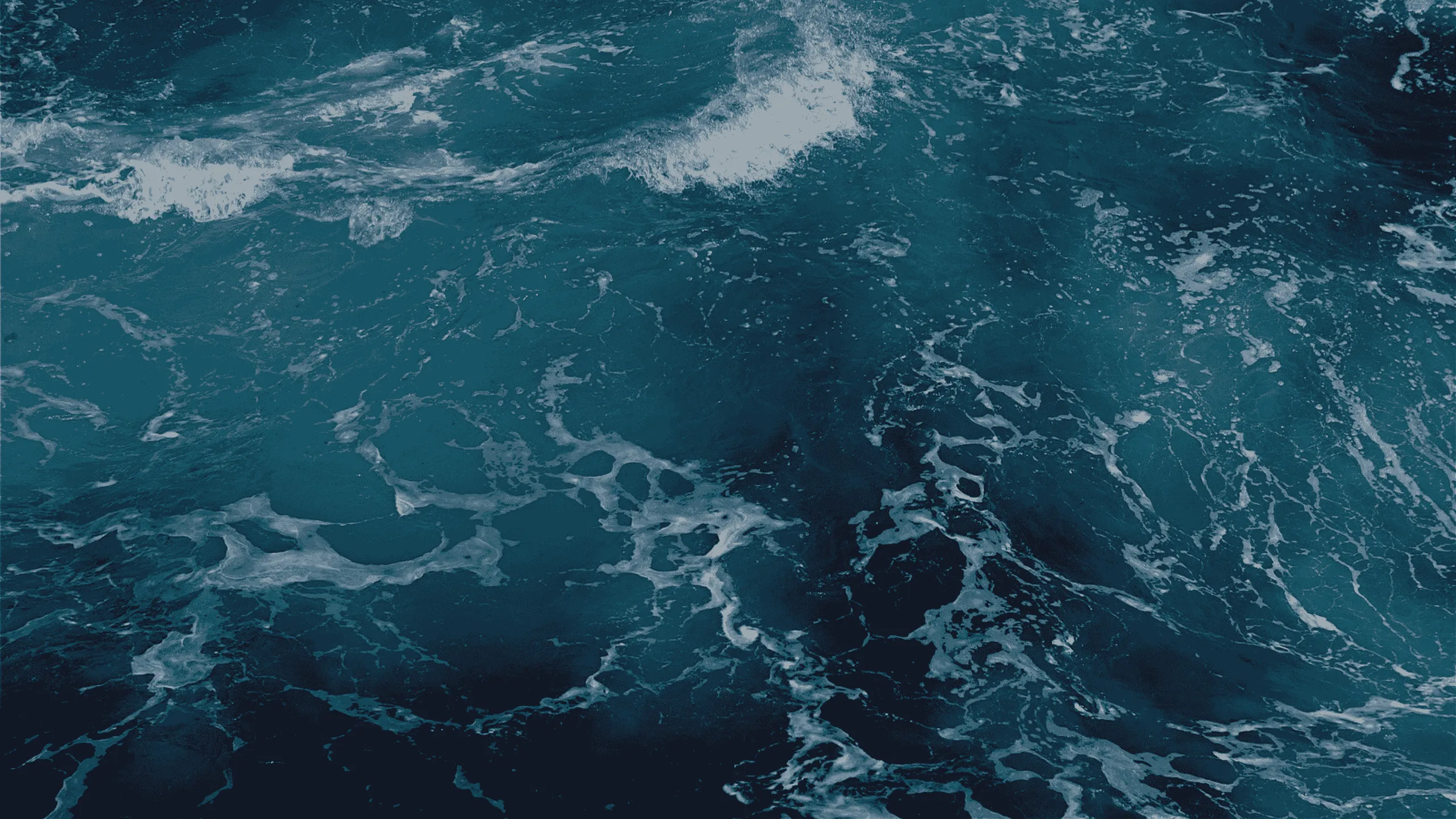 Deep blue ocean waves seen from above